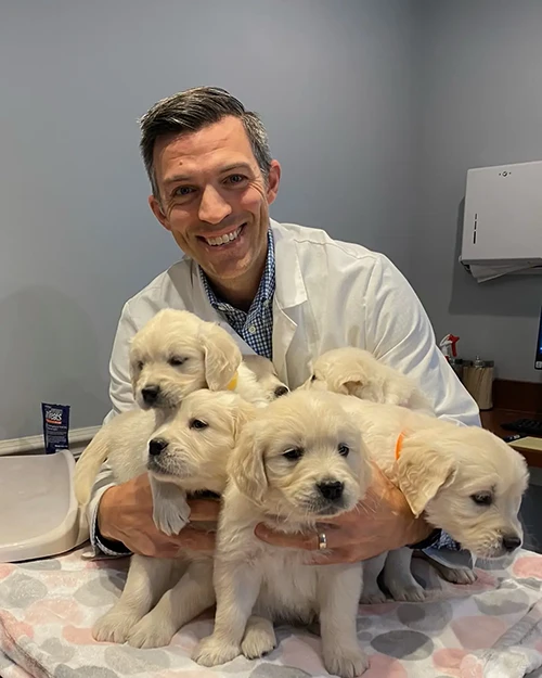 Dr. Greg with Puppies
